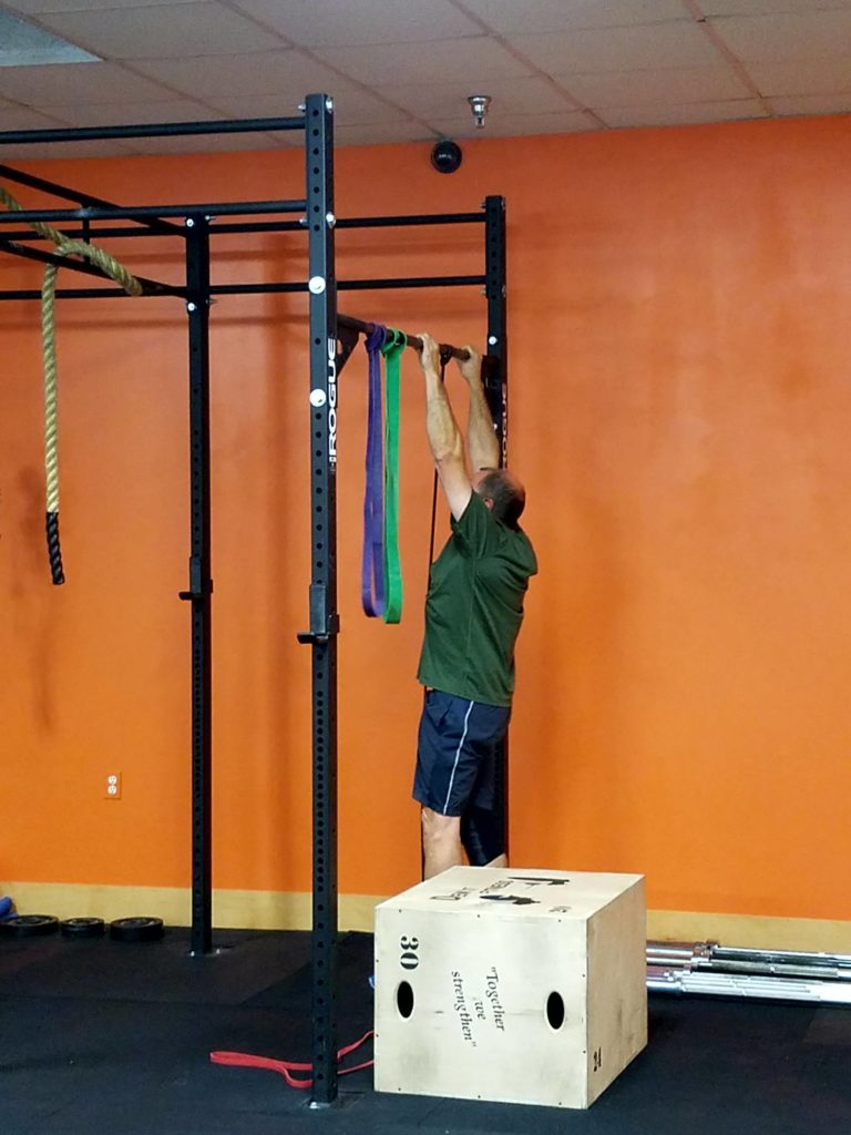 Moe hitting his first pull-up reps on the black band.
